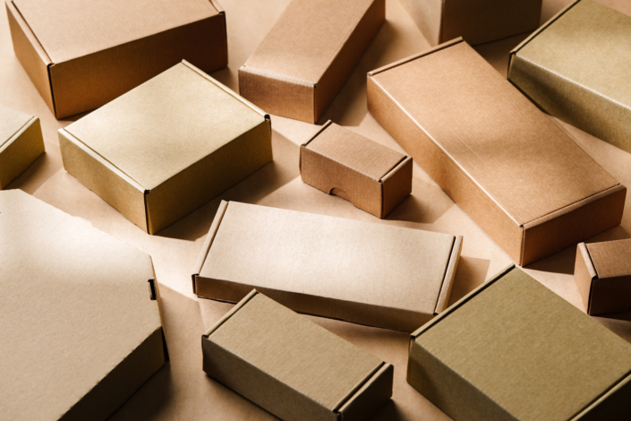 Multiple cardboard boxes arranged on a surface for packaging and shipping in a warehouse setting